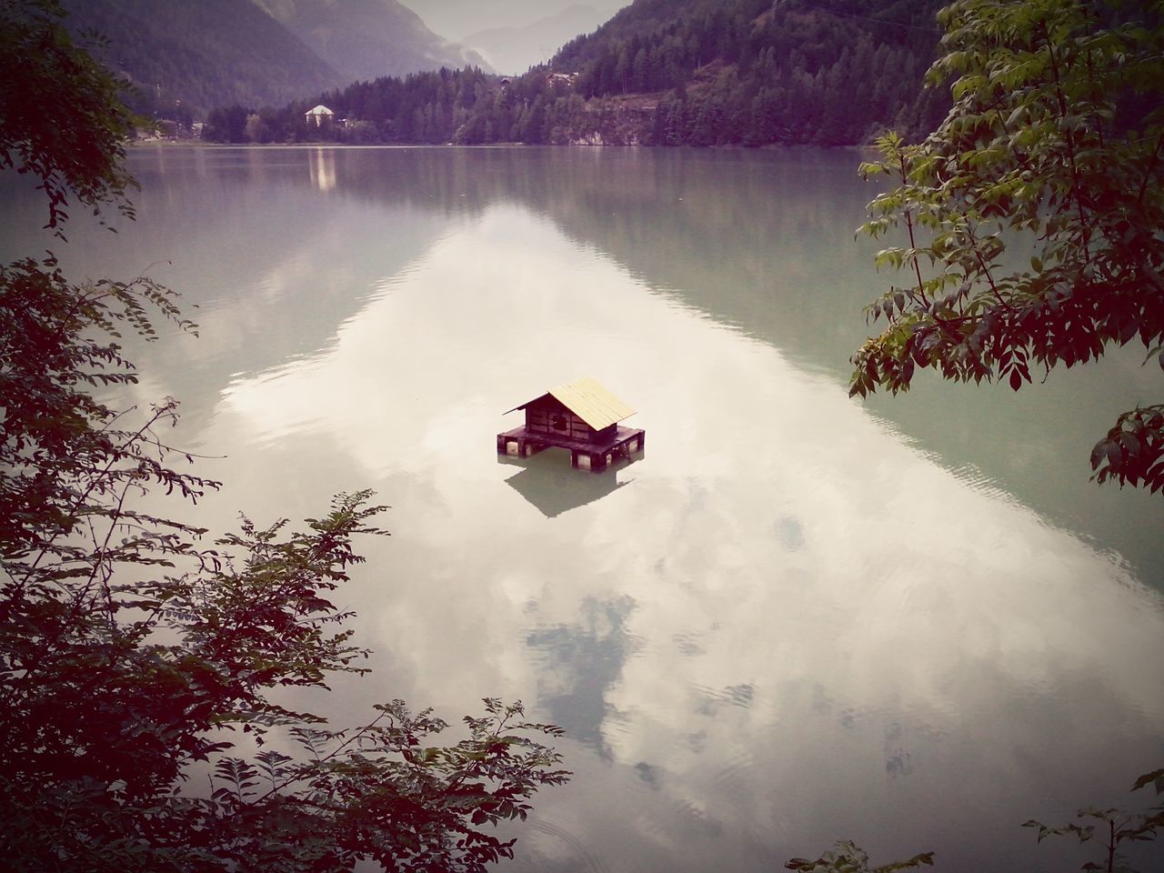 tree, sky, tranquility, cloud - sky, beauty in nature, nature, reflection, tranquil scene, scenics, mountain, built structure, day, architecture, outdoors, weather, cloud, no people, lake, house, forest