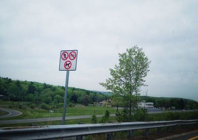 Road sign against sky