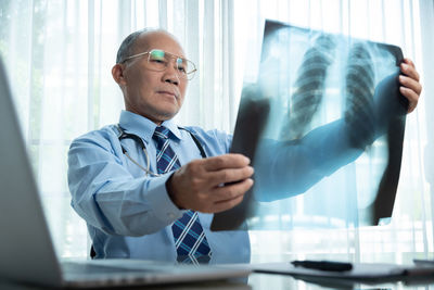 Doctor analyzing x-ray image in hospital