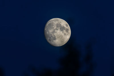 Low angle view of moon against blue sky