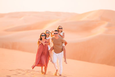 Portrait of woman on sand dune in desert