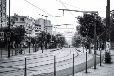 City street by buildings against sky