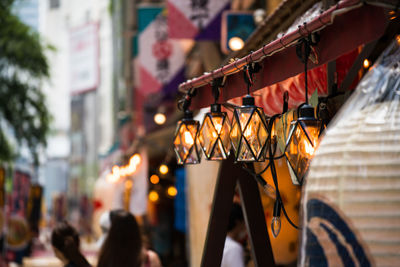 Close-up of illuminated lantern in city