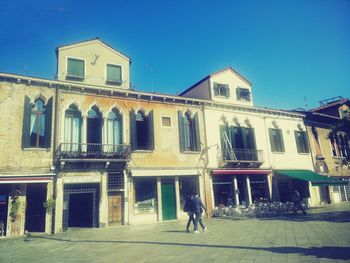 View of buildings against blue sky