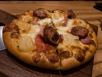 High angle view of pizza on cutting board