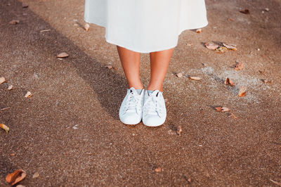 Low section of woman standing on ground