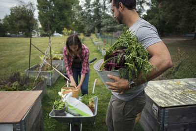 Man holding food while standing by plants