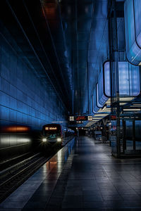 Train at railroad station against sky at night