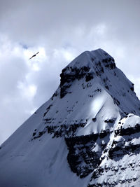 Low angle view of snowcapped mountain against sky