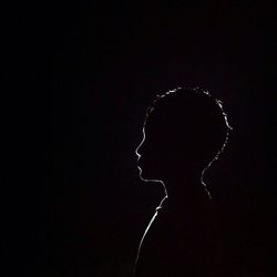 Portrait of silhouette man against black background