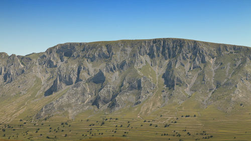 View of rocky mountains against clear sky