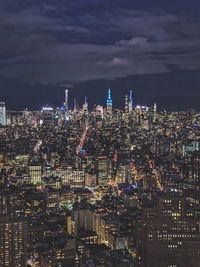 High angle view of illuminated buildings in city at night