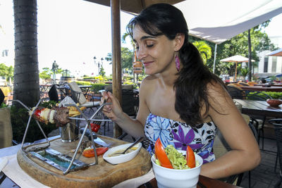 Portrait of smiling woman sitting at restaurant