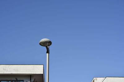 Low angle view of street light against clear blue sky