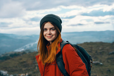 Portrait of smiling young woman standing outdoors