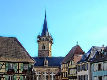 Low angle view of buildings against clear blue sky