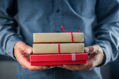 Close-up of man holding red box