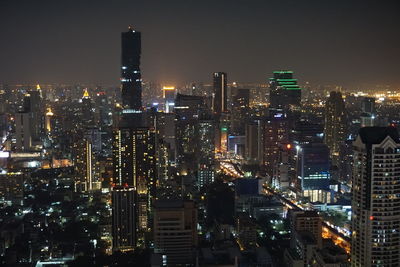 Aerial view of city lit up at night