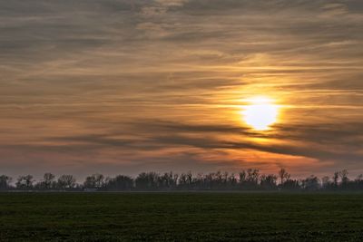 Scenic view of field against sky during sunset