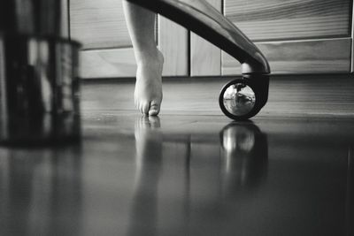 Low section of woman standing on floor at home