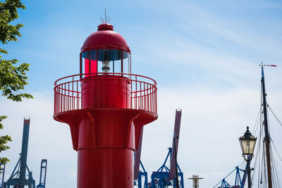 Low angle view of communications tower against sky