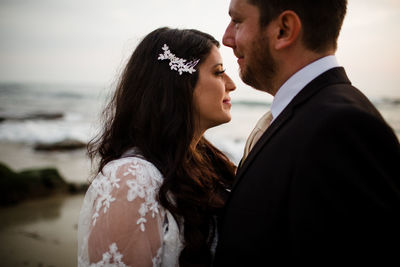 Young couple kissing in water at sea