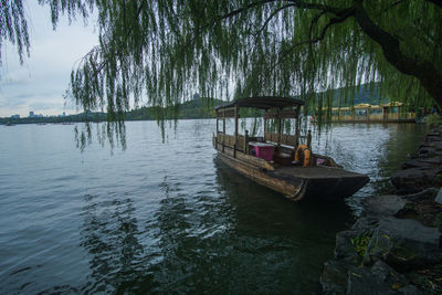 Boat in lake against trees