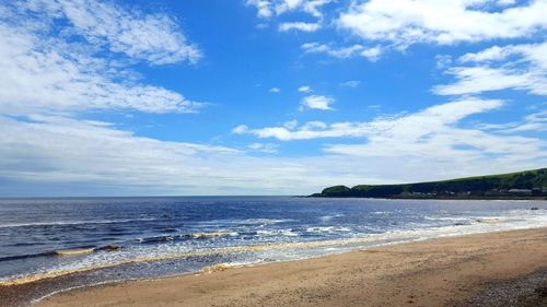 Scenic view of sea against cloudy sky