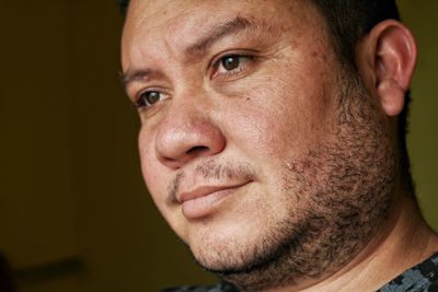 Close-up mid adult man sitting at home