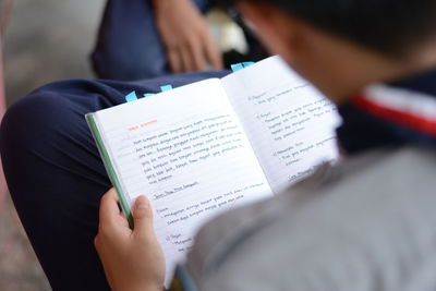 Close-up of hand holding book