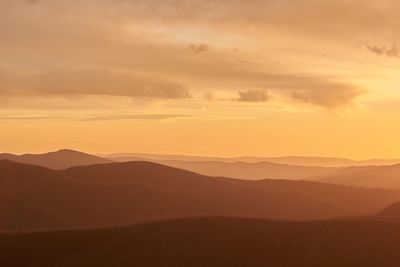 Scenic view of silhouette mountains against sky during sunset