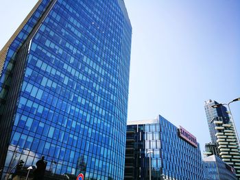 Low angle view of modern buildings against clear blue sky