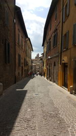 Narrow street amidst buildings in city
