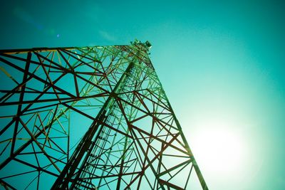 Low angle view of communications tower against blue sky