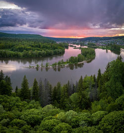 Scenic view of forest against sky at sunset