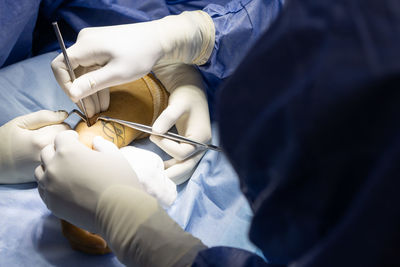 Midsection of doctor examining patient in hospital