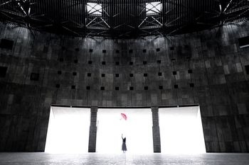 WOMAN STANDING BY BUILDING