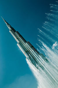 Close-up of airplane against clear blue sky