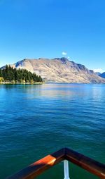 Scenic view of lake against clear blue sky