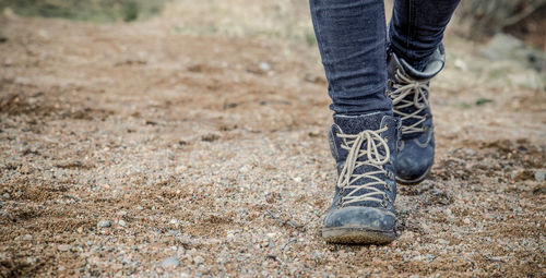 Low section of woman walking on ground