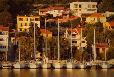 Boats in river with buildings in background