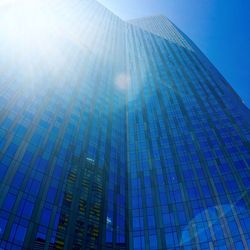 Low angle view of tall building against blue sky