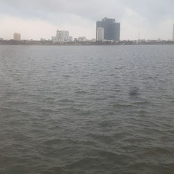 Scenic view of sea and buildings against sky