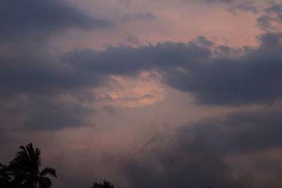 Low angle view of silhouette trees against sky at sunset