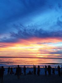 Silhouette of people on beach during sunset