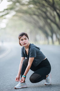 Portrait of young woman exercising in park