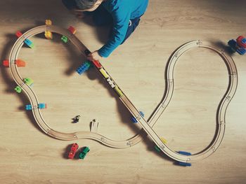 High angle view of boy playing with toy on floor