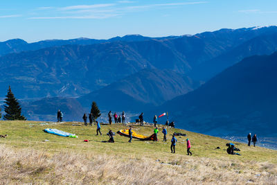 Winter panorama from monte avena.  paragliders prepare for departure. national park, belluno, italy