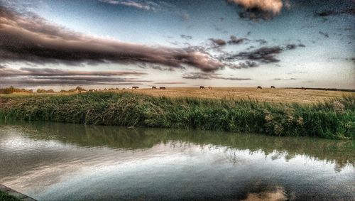 Scenic view of landscape against cloudy sky