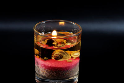 Close-up of decorative candle in glass